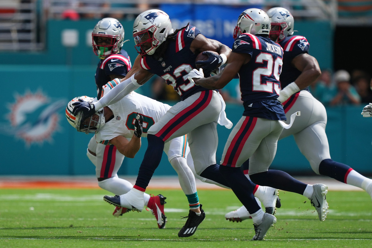 Oct 29, 2023; Miami Gardens, Florida, USA; New England Patriots safety Kyle Dugger (23) stiff arms Miami Dolphins safety Jevon Holland (8) while running back an interception during the first half at Hard Rock Stadium. 